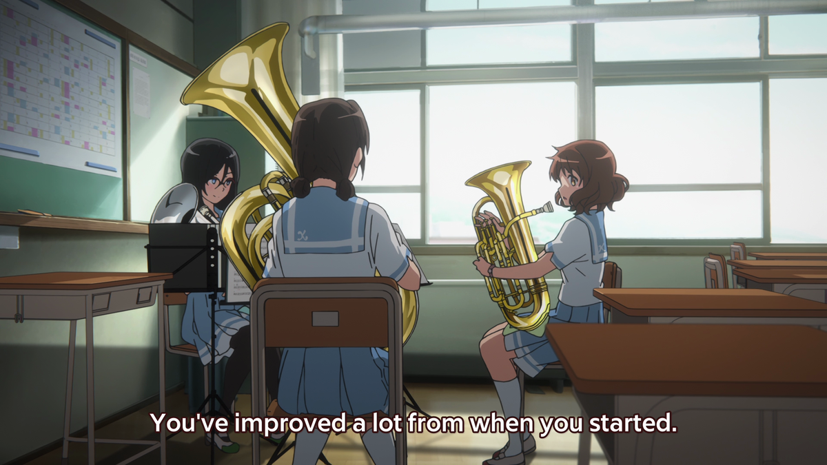 It's acknowledged that Kumiko has improved, but, once again again again, the box imagery appears with the shot from outside the classroom looking slightly down on Kumiko. She may have improved, but it's still not enough, she's still below the literal bar being created by the box.