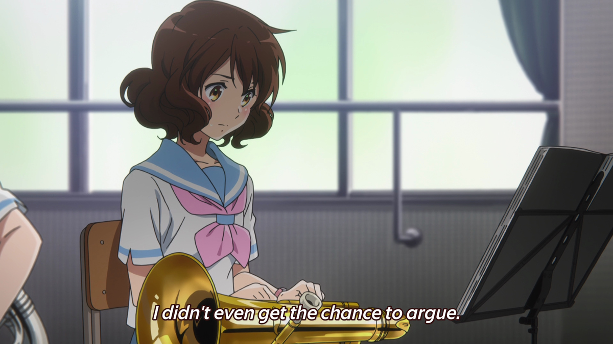 The lighting on Kumiko's face is darkened, reflecting how she feels distraught. Her face is then lit up upon further realization that everyone is entirely serious about making it to the Nationals, and sees herself as dead weight because her playing was holding the band back.