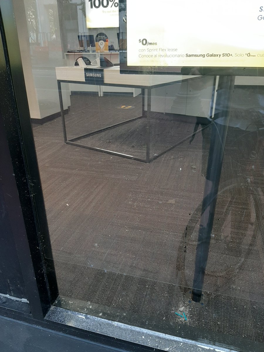 The  @sprint store had been broken into at some point in the last 50 days of protests. Broken glass was visible all over the store.