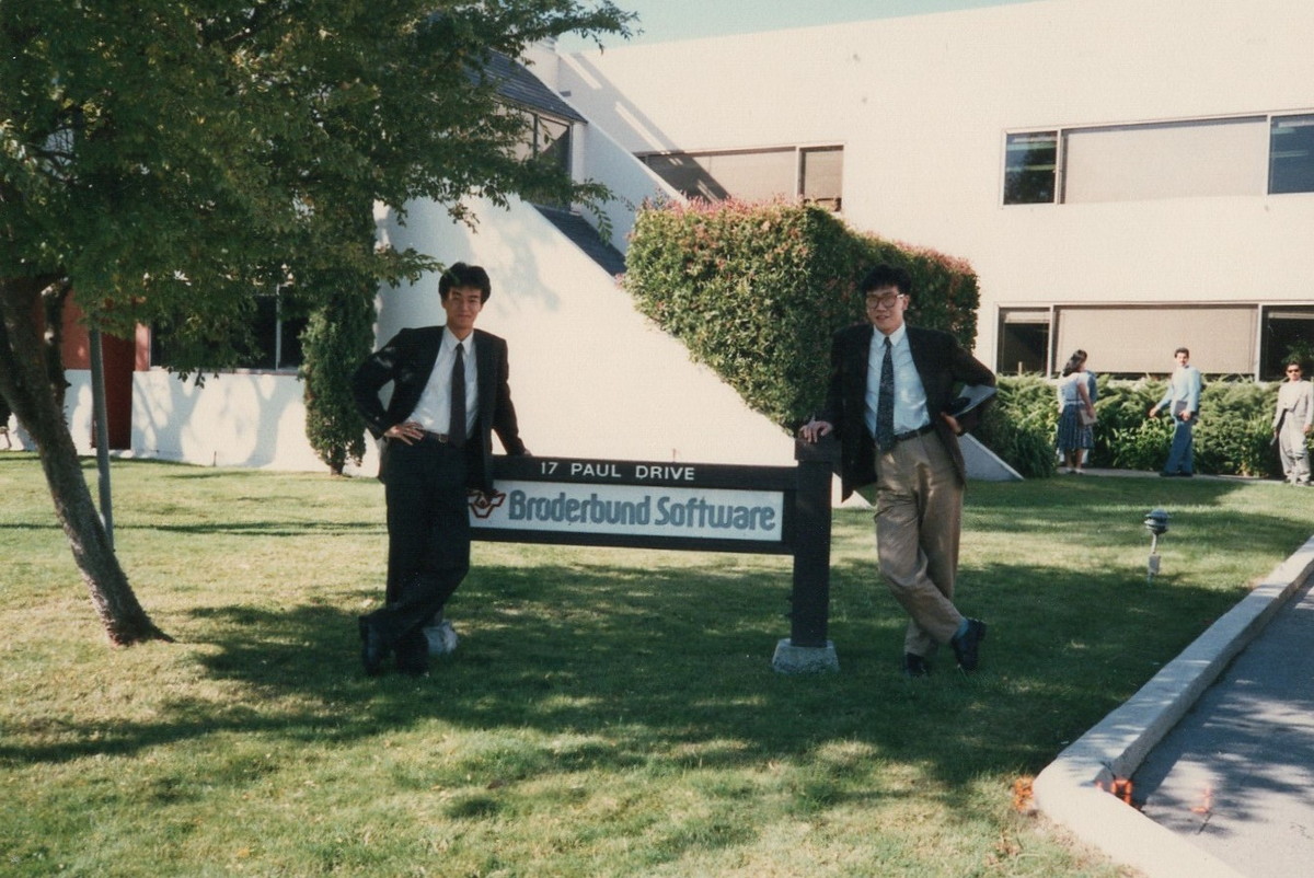 Apparently members of this group would visit Silicon Valley game companies on yearly trips! Here's a bunch of them in front of Electronic Arts in 1986, and Sakaguchi and Tanaka at Broderbund in the same year. (Source:  https://www.resetera.com/threads/old-photos-of-pre-1987-square-featuring-young-sakaguchi-w-o-mustache-and-others.121767/)