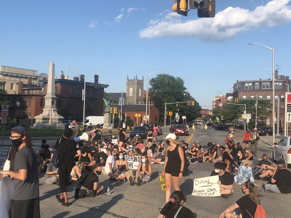 aselahcurtis's tweet photo. Protestors have reached their destination. They are now sitting in the middle of Merrimack outside Lowell City Hall. https://t.co/q64SwWHKU2