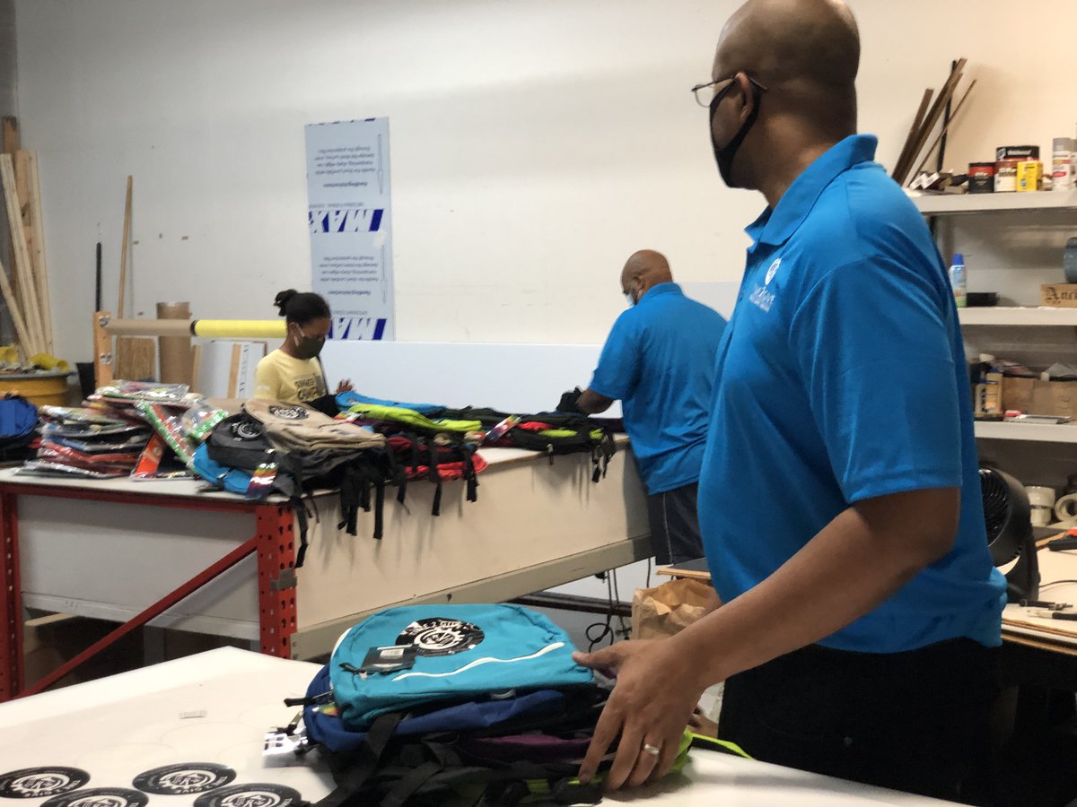 Time2GiveInc's tweet photo. Teamwork makes the dream work! Spent a few hours this afternoon adding logos and school supplies to 400 bookbags to be given away 7/25 along with groceries. Details in the flyer - pull up! https://t.co/cKkrB7radq