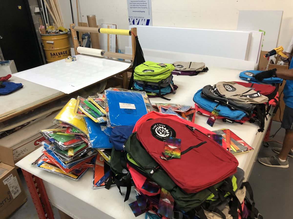 Time2GiveInc's tweet photo. Teamwork makes the dream work! Spent a few hours this afternoon adding logos and school supplies to 400 bookbags to be given away 7/25 along with groceries. Details in the flyer - pull up! https://t.co/cKkrB7radq