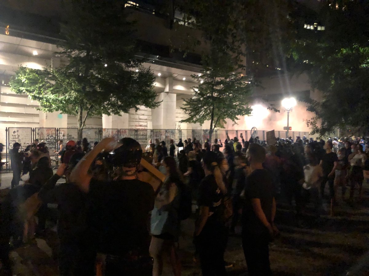 Protesters started marching. There’s some smoke and confusion. More efforts to take down fence around JC.