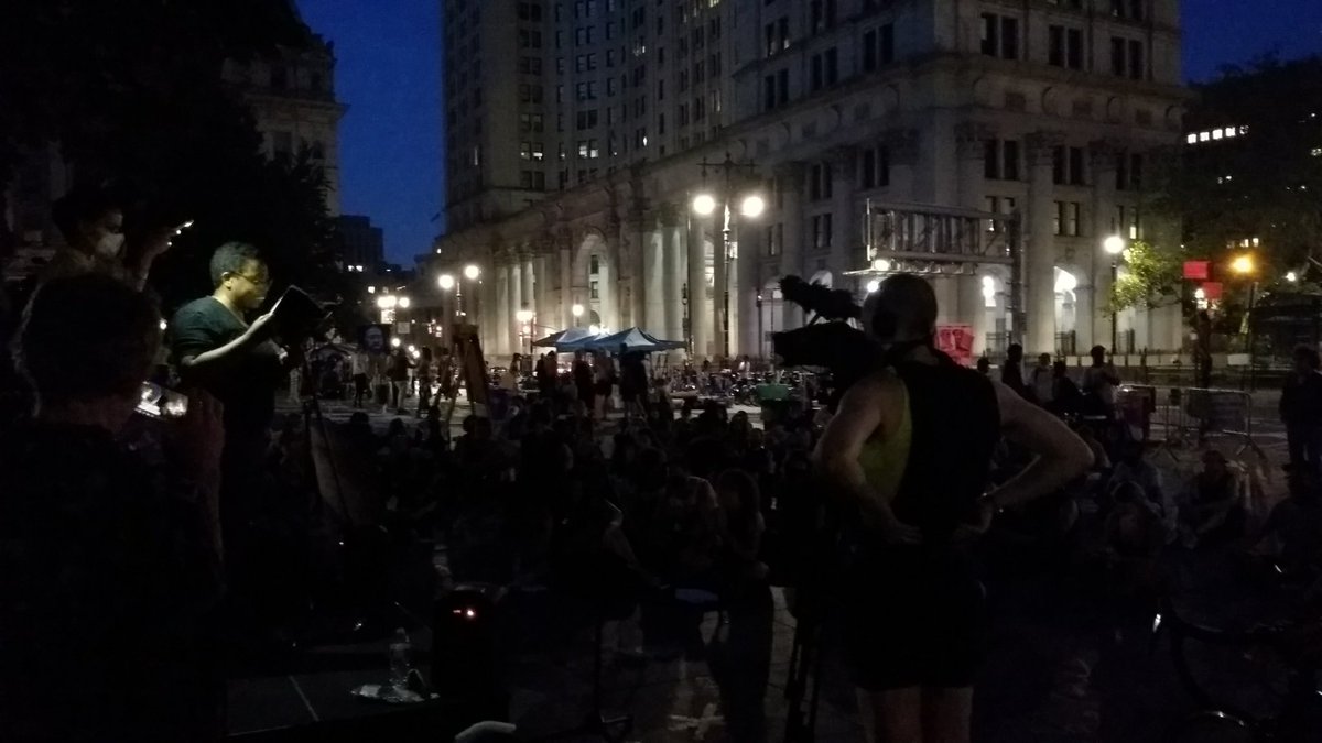 protest_nyc's tweet photo. @amabirch reads to a large crowd from her book #FergusonInterviewProject ahead of the upcoming 6th anniversary of the killing of #MichaelBrown. https://t.co/cGsXYLrscA