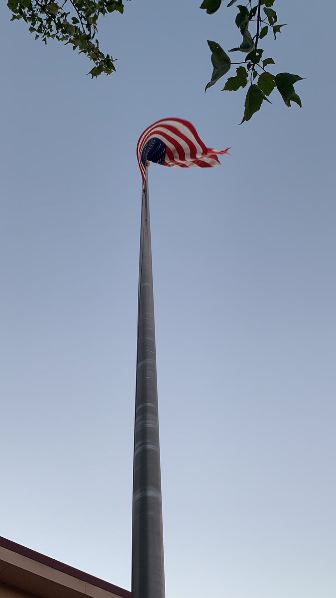 A protester just lowered the American flag flying outside the precinct. The entire crowd cheers.