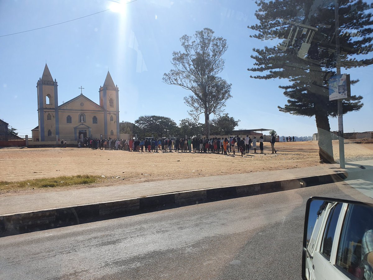 AngolaRob's tweet photo. Irony. In order to implement proper social distancing, everyone waits outside the cathedral for their turn to enter. https://t.co/LR3nIS4Jp6