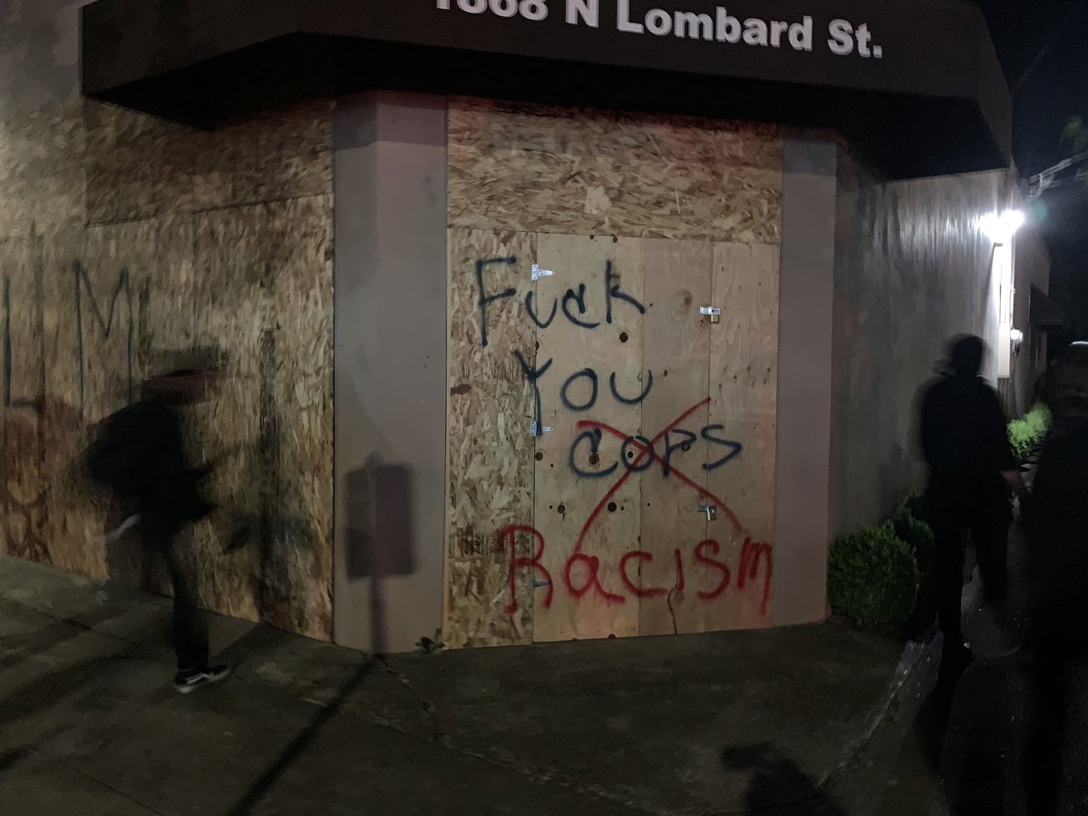 The march is finally arriving at the PPA. Group is being led by some protesters wheeling a dumpster down the middle of Lombard. It’s a big march, maybe 500 folks? The PPA is boarded up and looks abandoned. (not saying it IS abandoned.) the crowd almost passed it accidentally.