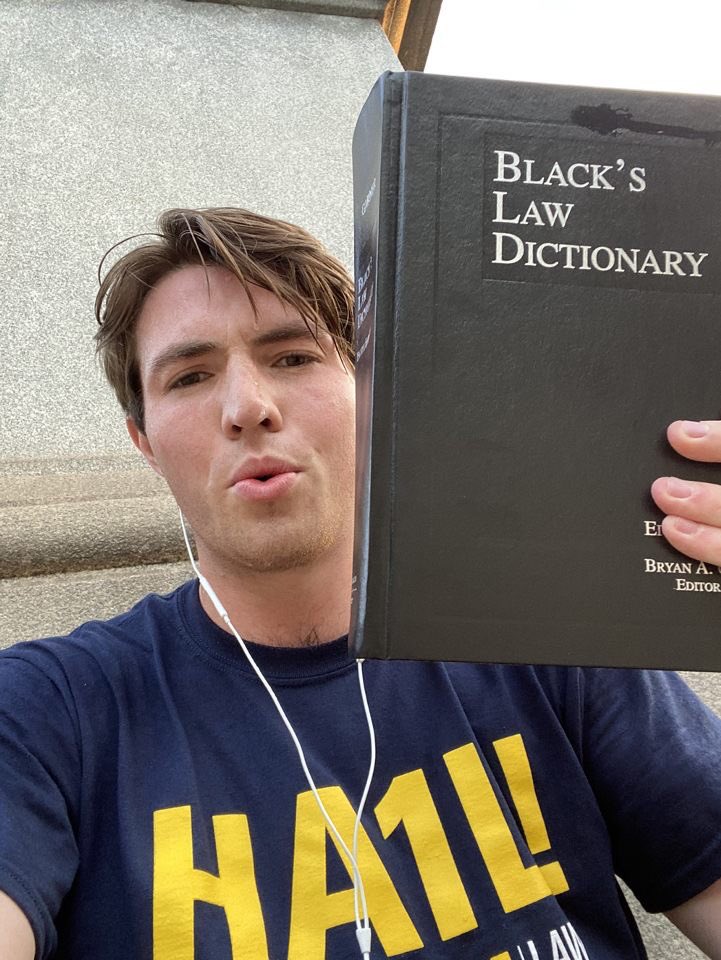 liv_torres's tweet photo. Alex ran a mile holding this law dictionary, I’m just brimming with jealousy over his shirt. The quest for victory continues! #SALSAW https://t.co/zi2zUGTOC2