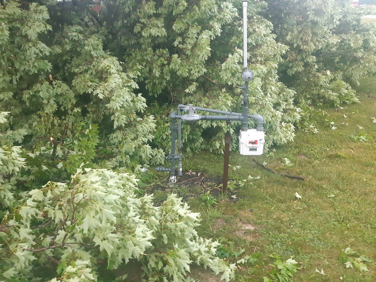darrenmohle's tweet photo. Felt like a W Canada plow wind just roller through. Causalities include tree and farm sign, somehow the tree completely missed the Nat Gas hookup.  #ONStorm #ontag https://t.co/A03aswXek7