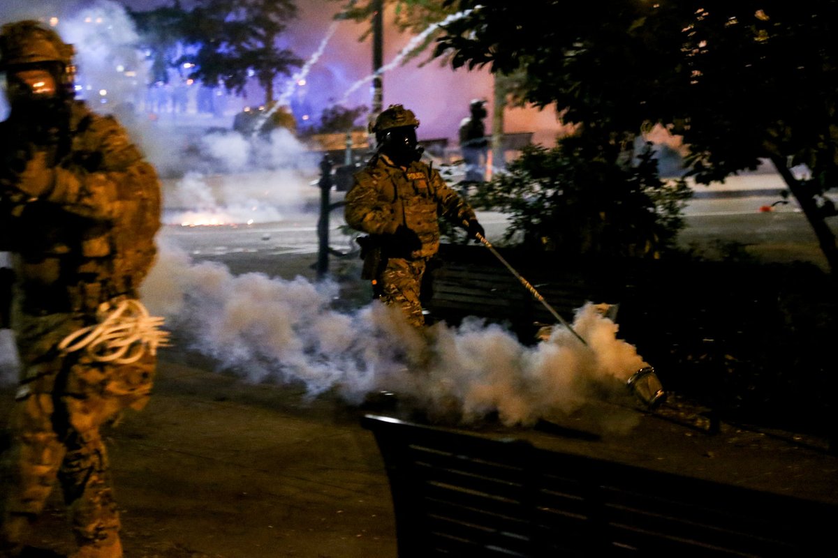 Not to make light of things, but someone told me that in this shot of mine from Friday it looks to them like the officer is casually walking some kind of smoke dog, and now I can't see it any other way