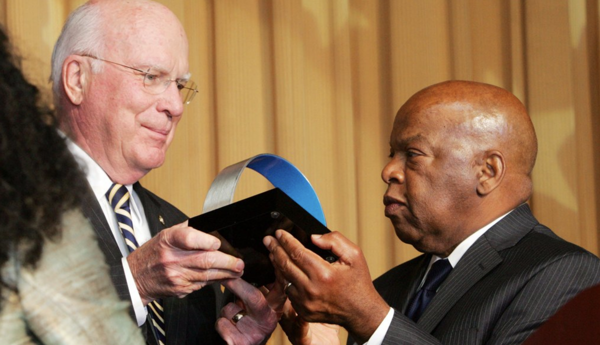 A photo from our annual awards dinner showing Congressman John Lewis presenting an award to Senator Patrick Leahy.