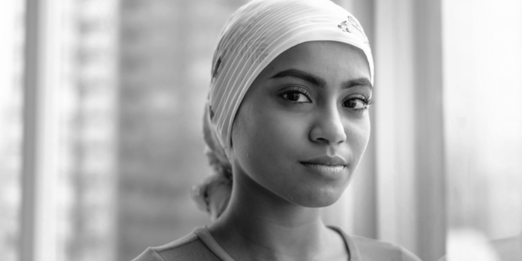 woman in head scarf looking at camera