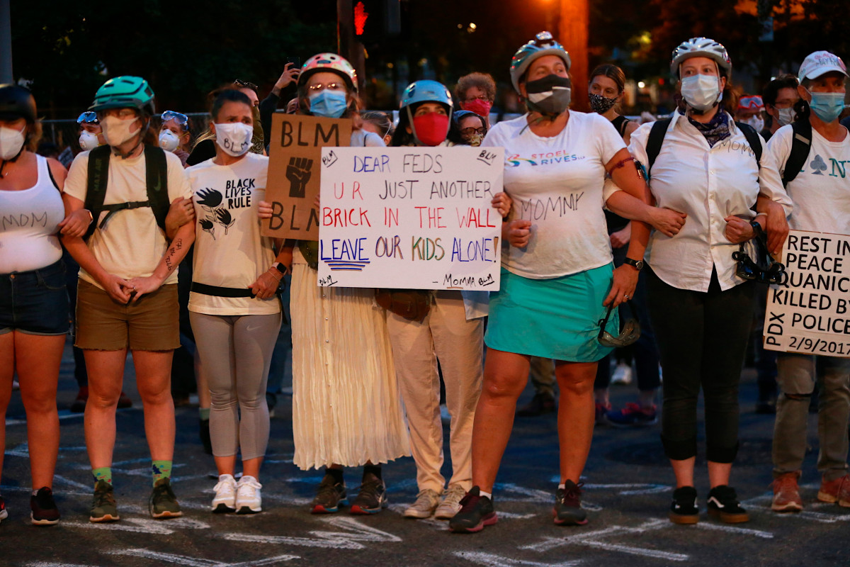 nypost's tweet photo. Portland moms form human shield to protect protesters from feds https://t.co/XvmbQBn1QU https://t.co/pCtkxRMmor