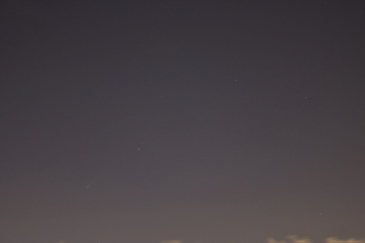 davez011's tweet photo. Downtown Miami has to be one of the worst places to stargaze (bright lights everywhere, sea level, daily thunderstorms), but we still caught the briefest glimpse of NEOWISE from the balcony last night.  Just a faint light with no tail to us but the camera saw more (bottom left) https://t.co/ePvVZ9RxRC