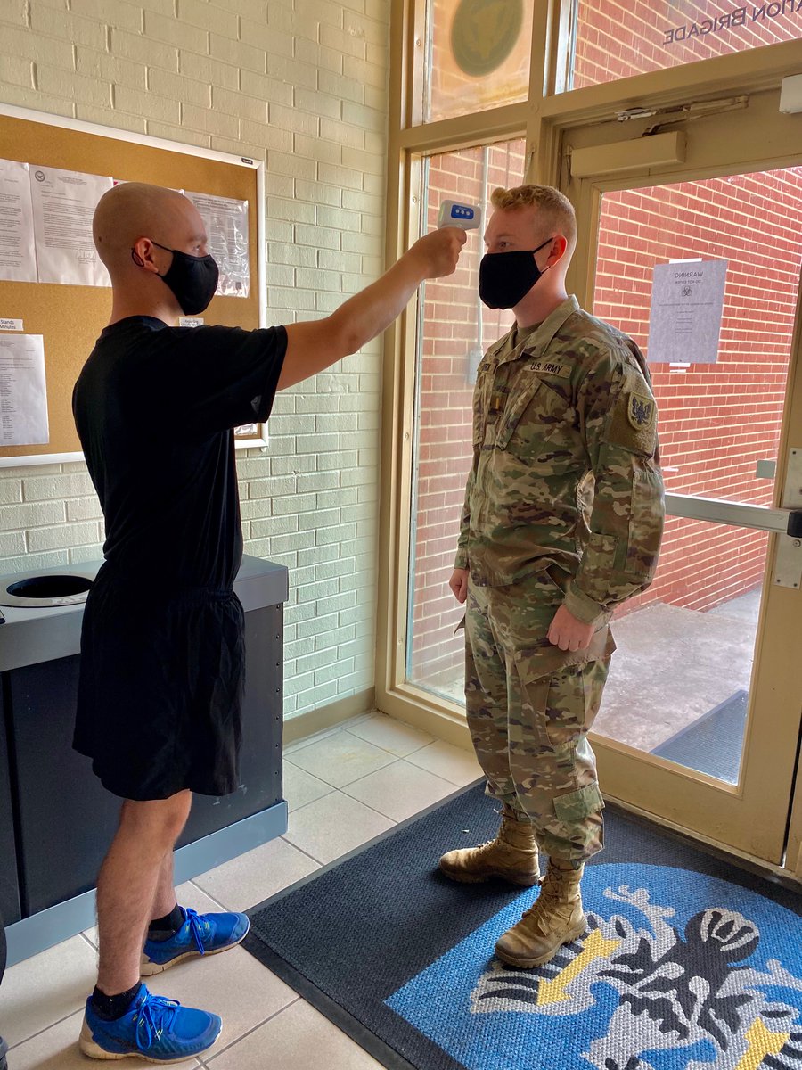 11thECAB's tweet photo. Spc. Randall Geisler,  a @usarmyreserve aviation operations specialist with the #11thECAB HHC, checks the temperature of 2nd. Lt. Jordan Carrick to help mitigate the spread of COVID-19 during a hybrid battle assembly in Fort Carson, Colorado, July 18. https://t.co/Ube5c53Mef
