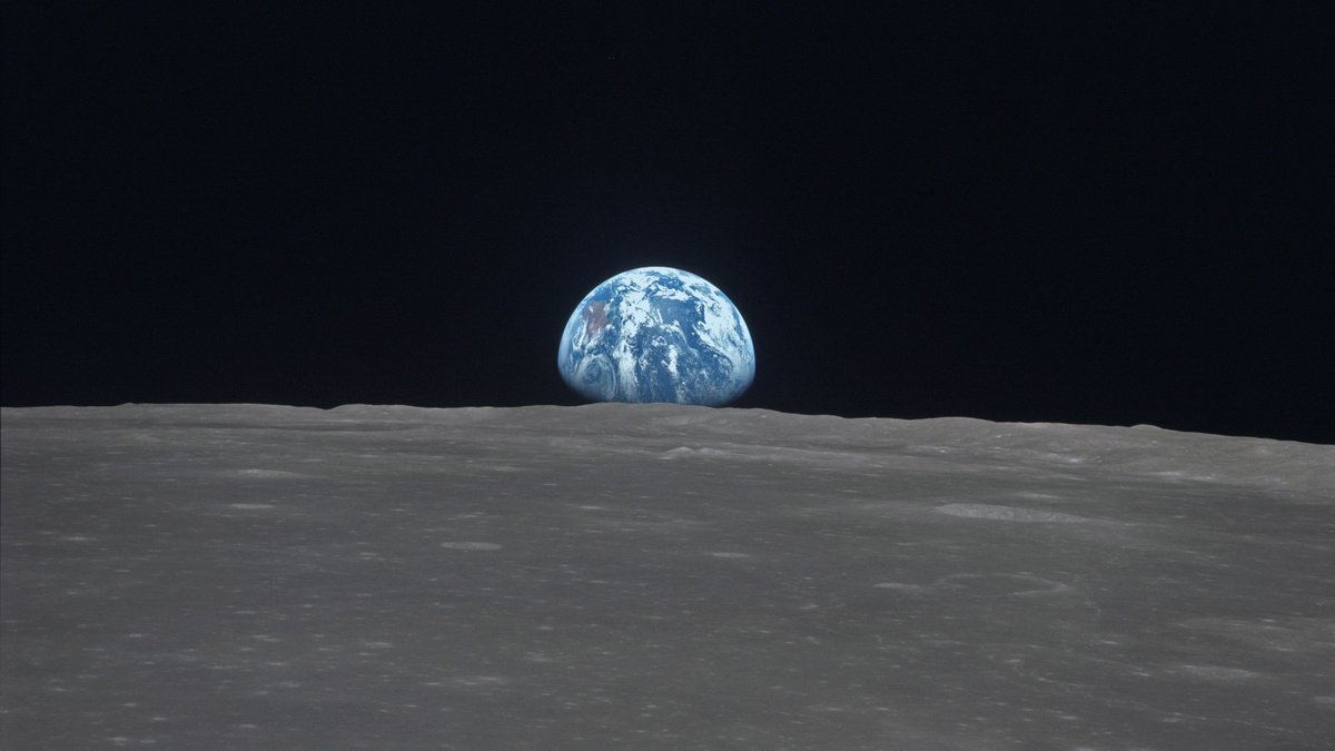  Earth rising above surface of the moon