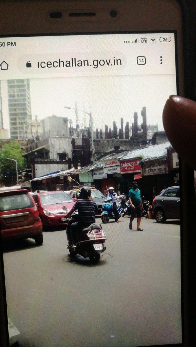 TheRockMaivia's tweet photo. First the picture of vehicle I got in this echallan is not mine and also I haven't used my vehicle for months now.
 second there are no skyscrapers in Badlapur.
Third the echallan is for one way but in picture we can clearly see the traffic. And the number plate is blurry. https://t.co/v5Dl9sWzHM