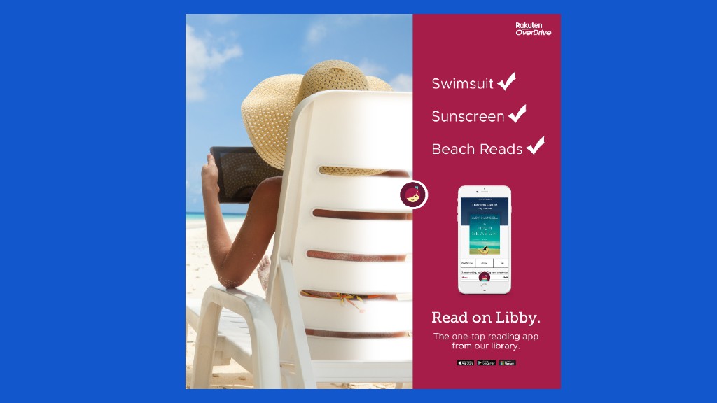 a woman sitting on a beach chair reading from a tablet on the beach