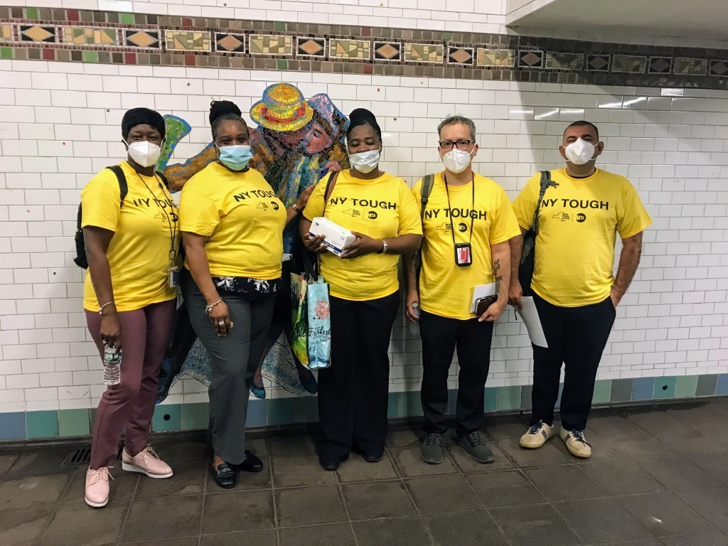 NYCTSubway's tweet photo. 👋 It’s day 1 of Phase 4 and we've been disinfecting 24/7.

We still need you to wear your mask. They're available for free anytime at booths, and starting today volunteers are handing out thousands on subways and buses.

Meet the Mask Force 👇 https://t.co/4l38OkgnVg