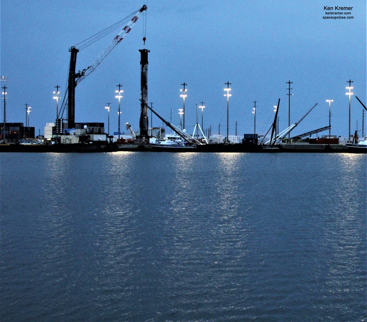 ken_kremer's tweet photo. Fully leg retracted #Falcon9 2x recycled 1st stage at blue hued dusk with water reflections-torrentially drenched by Space Coast rains this evening Jul 27 @PortCanaveral. #SpaceX from #AnasisII and #Demo2 launches https://t.co/zSYdd0opVe