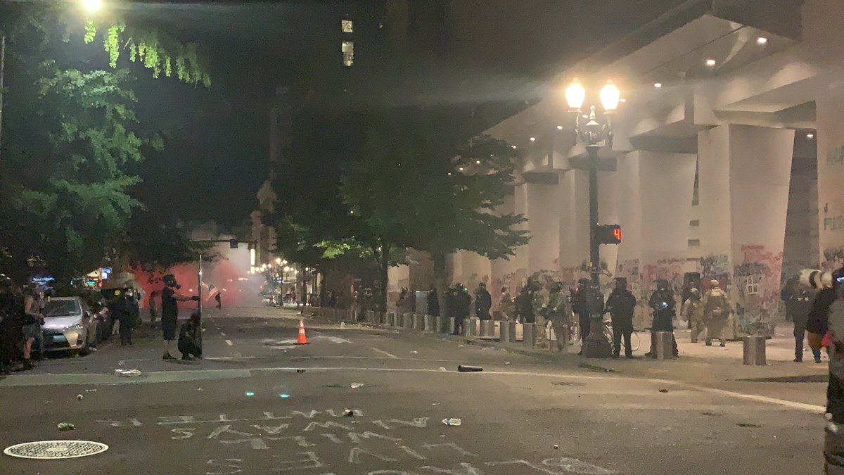 Continued standoff. I believe this person with the shield is filming behind it. Front of the shield says “press.” Amazing.