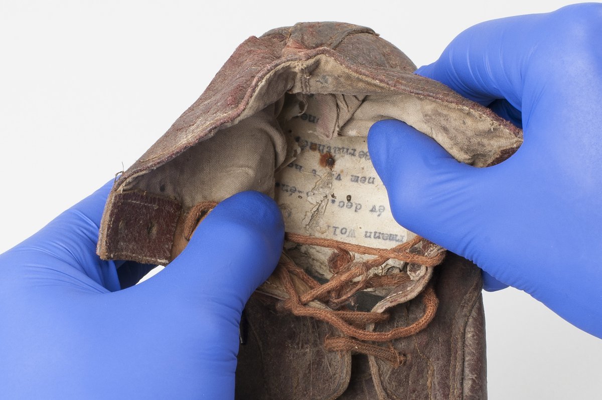 AuschwitzMuseum's tweet photo. A touching #discovery was made during conservation of shoes of child victims of the German Nazi #Auschwitz camp: a handwritten inscription with the name of Amos Steinberg deported from #Theresienstadt Ghetto with his mother &amp; documents in Hungarian: https://t.co/lByKFNXfVc https://t.co/EK3zoYtTYj