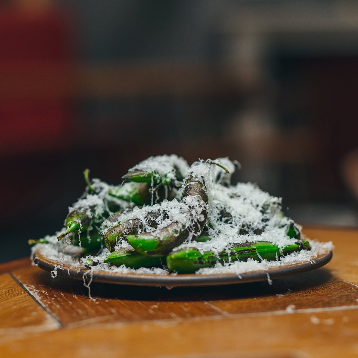 Wood-Grilled Hot Dog Peas, Shaved Berkswell Plump Cornish pods from @natoora, grilled over wood till the skins blacken and steam the poppy little peas inside. A blizzard of one of my favourite sharp tangy ewe's milk cheeses. My perfect early evening snack. #brunswicktwopointoh