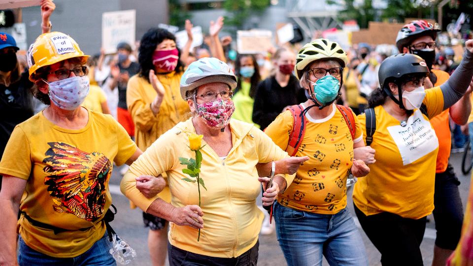 nycjim's tweet photo. Wearing bike helmets and bright yellow shirts, #PortlandMoms are becoming a potent force in protests against Federal agents. https://t.co/9hMDuXEGtt https://t.co/SqQa3xm9zg