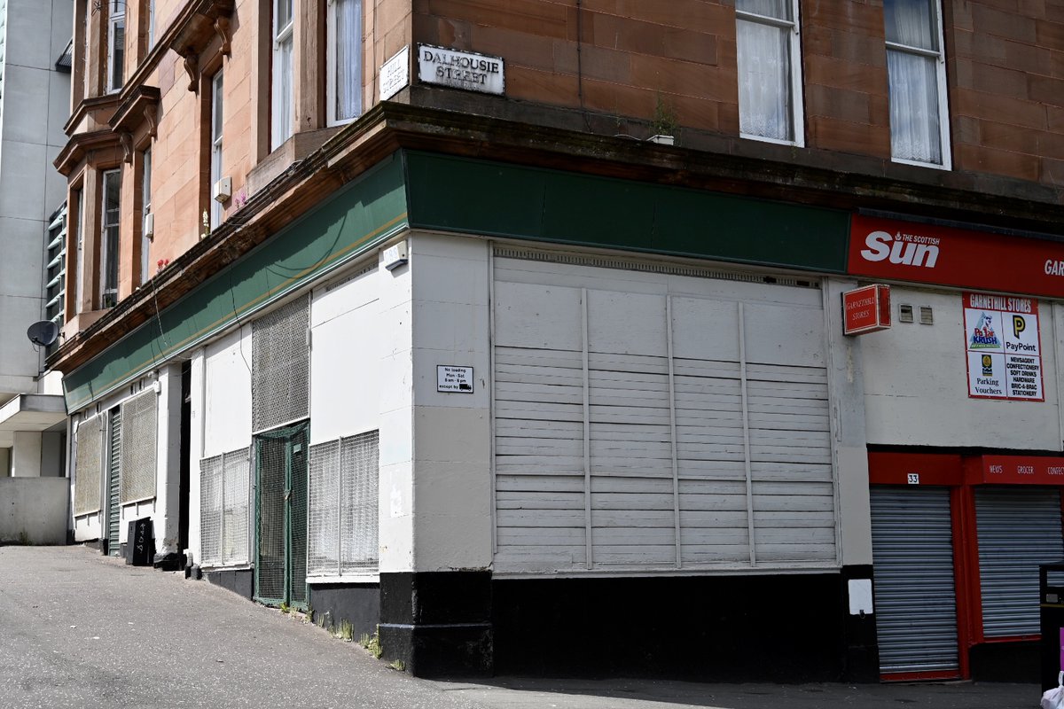 Side view of shop on a steep corner, green paintwork and whi