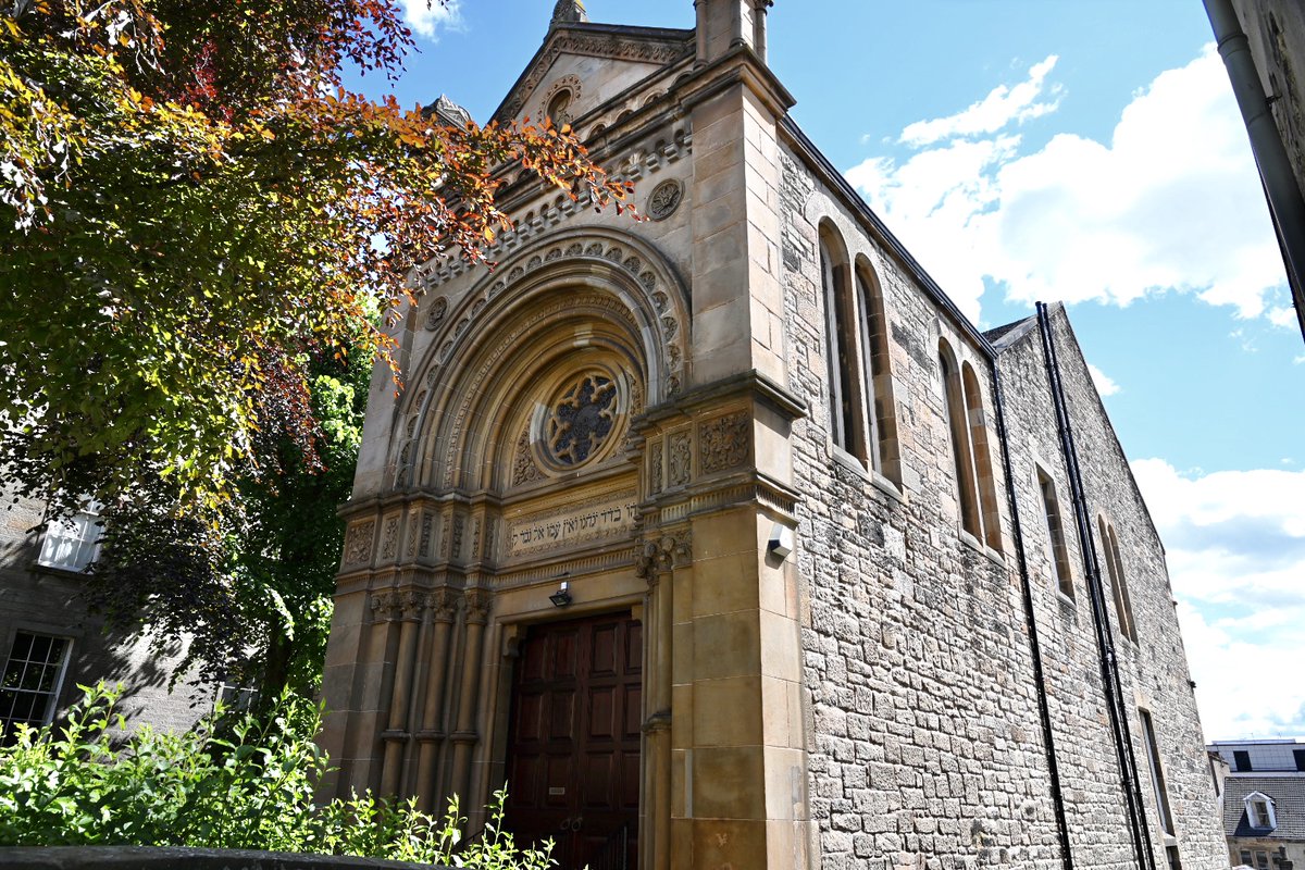 View of a blonde sandstone synagogue, elaborately carved arc