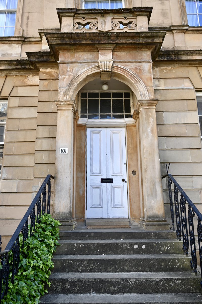 Close up of blonde sandstone tenement showing entrance steps