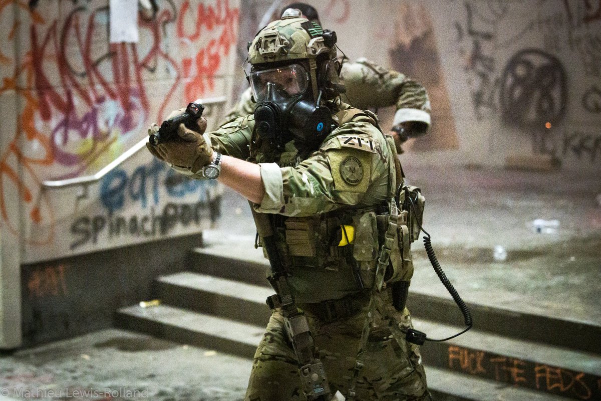 Unmarked federal LEO with suppressed AR and another with sidearm drawn and sweeping the crowd in Portland. Clear escalation of state violence against unarmed civilians protesters. From:  @MathieuLRolland