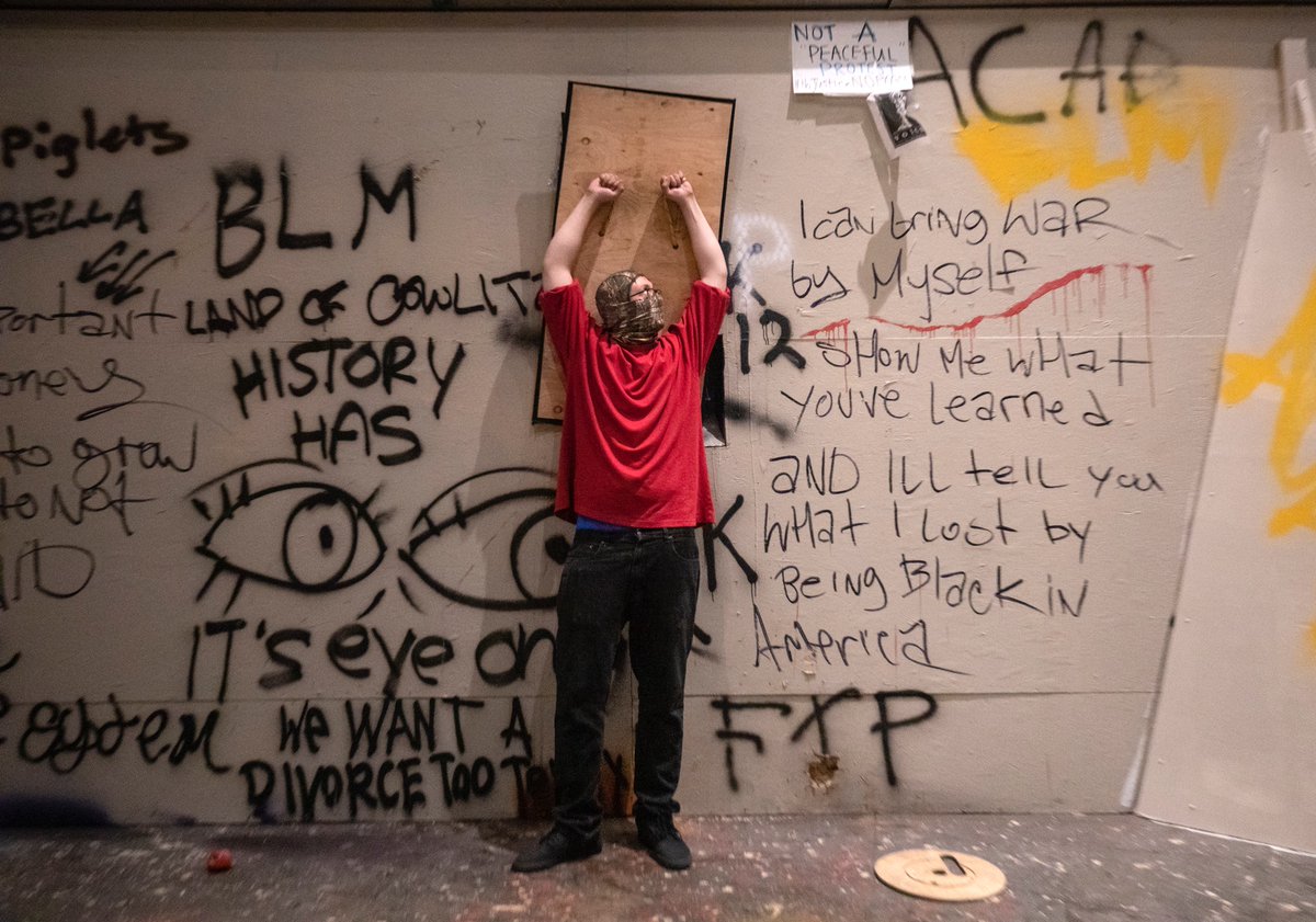 After the march, the crowds thinned a little and protesters converged on the courthouse. Some blocked the makeshift openings that LE officers use to shoot out crowd control munitions. Others tore off pieces of plywood (there’s a video posted earlier on my timeline).