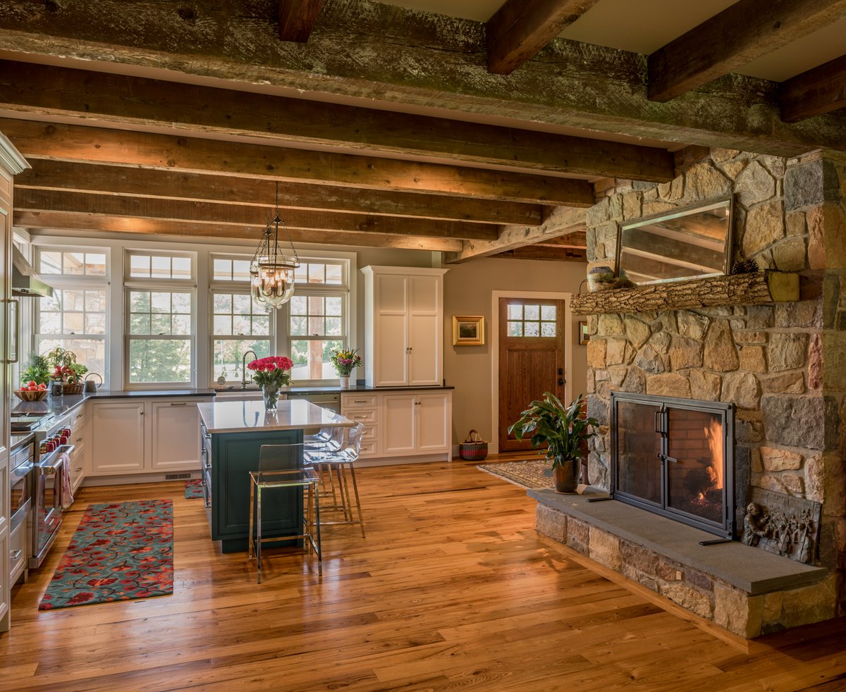 The exposed beams and stone walls create a rustic quality for this charming kitchen, but with contemporary accents like acrylic bar stools and modern appliances, classic meets chic in this dreamy space. <a href="/BHG/">BetterHomes&Gardens</a> @newoldhouse #rusticmodern #TransformationTuesday