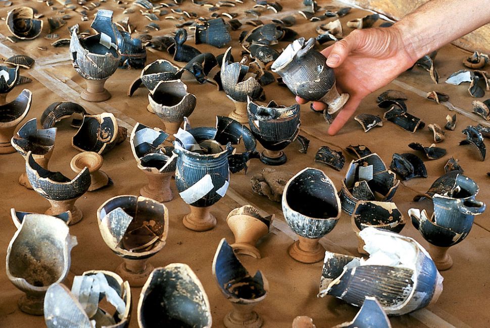 The floor of the chamber was strewn with broken high quality pottery, mostly drinking cups, mostly imported and mostly Greek, broken and deposited there as sacrifice...