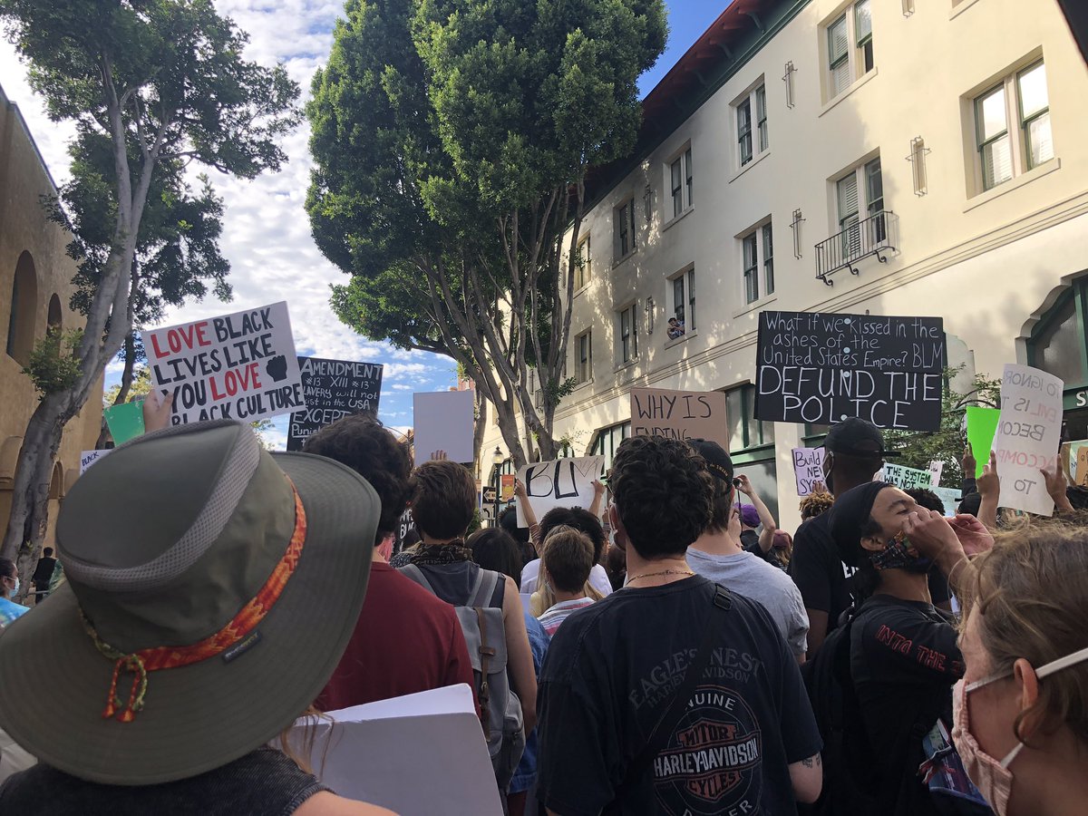 MackenzieShuman's tweet photo. The protesters are LOUD. People sitting outside eating at restaurants and those hanging outside their apartment windows are joining in the chants. #BLMSLO https://t.co/iShMM83PwO