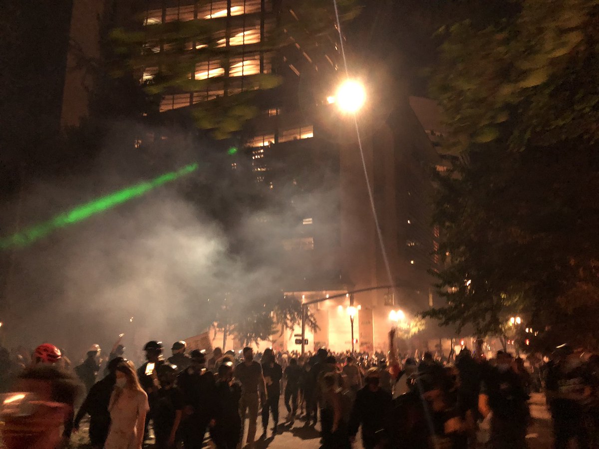 Lasers and spotlight from the courthouse roof. At least partly targeting people on the ground with lasers.