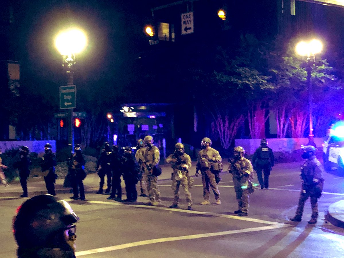 A line of officers cordons off the federal office building and Schrunk Plaza, generating attention and heckles.