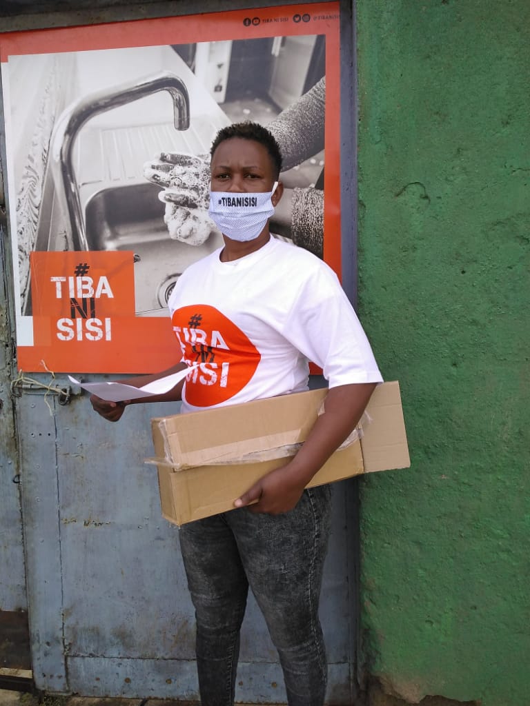 One of our mask distributors on her way to give out masks to vulnerable people in Dandora. These ladies have played a big role in ensuring we have the biggest impact in our communities. #TibaNiSisi