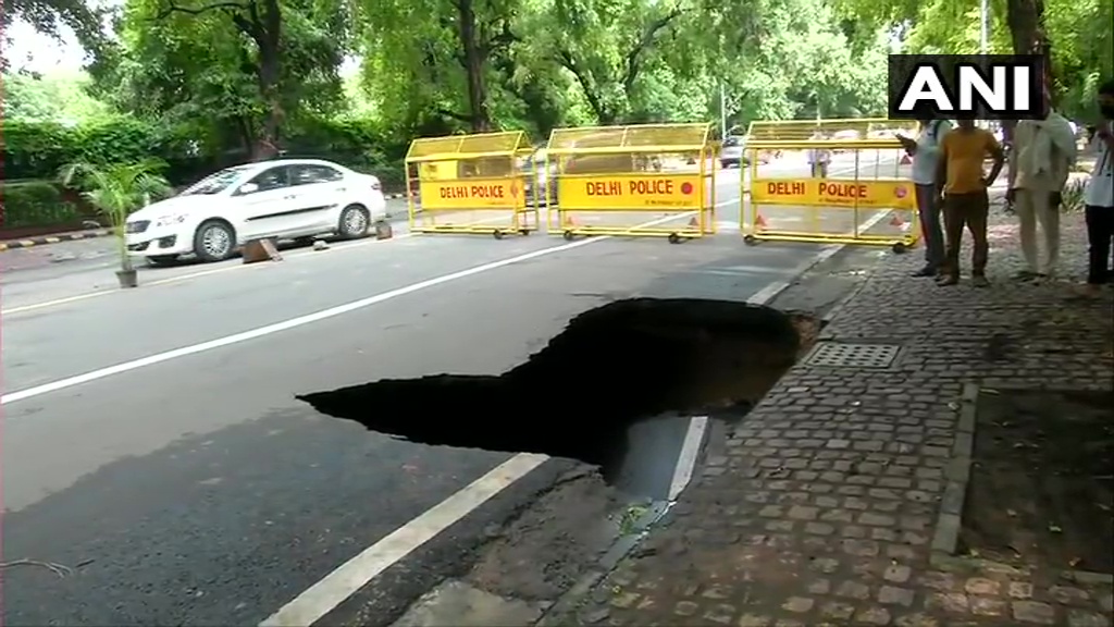 ANI's tweet photo. Delhi: Part of Ashoka Road caved in following heavy rainfall in the national capital region today. https://t.co/WoWgMkSGmA