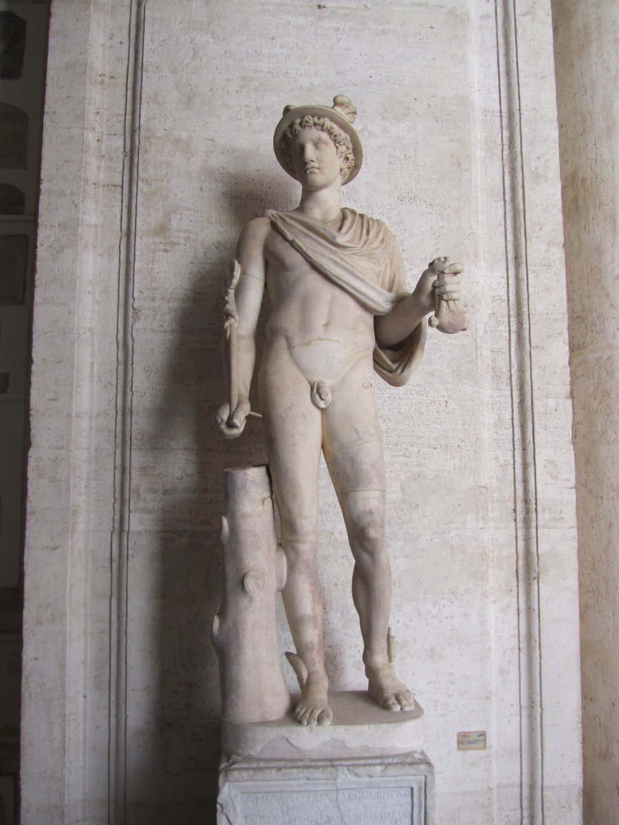 . #Wednesday is 'dies Mercurii', day of #Mercury, the God of commerce, communication & travels, protector of swindlers & thieves. This II AD statue at #MuseiCapitolini represents him, recognisable by the caduceus (the staff entwined by serpents) and the petasos (the winged hat).