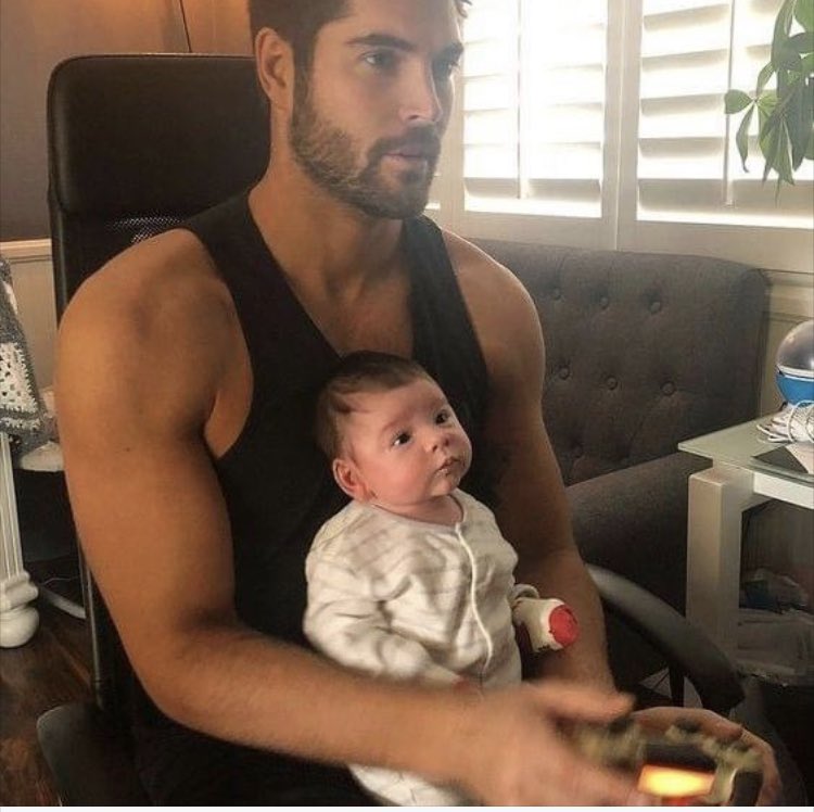Can someone tell him why <a href="/lucas_jones01/">Lucas Jones</a> looks so cute with a baby in his lap?