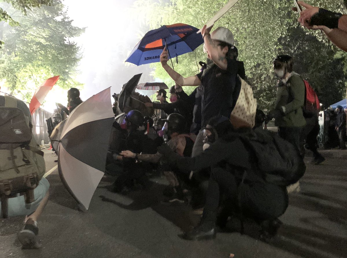 This is the end of the line that I saw staying through the tear gas. Lots of umbrellas.