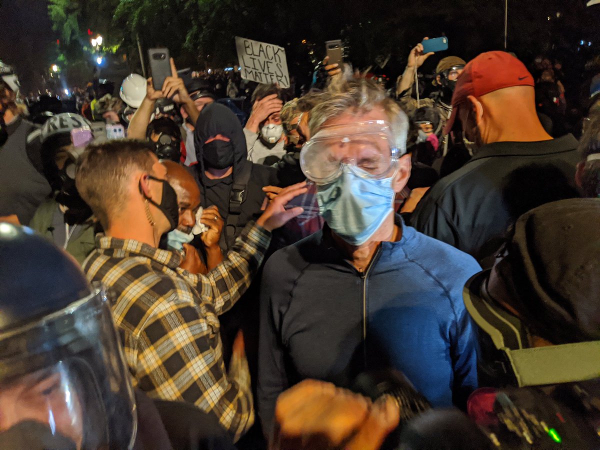 Mayor Wheeler with eyes closed, coughing, suffering from the tear gas."How does it feel, Teddy?" someone shouts.