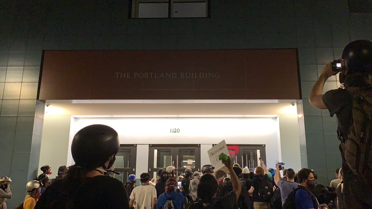 Ted just walked into the Portland Building. Someone threw a paint balloon at the door as he departed. Crowd is regrouping now. And coughing.