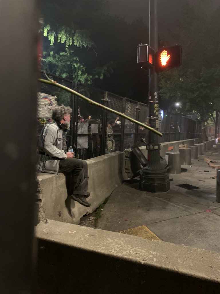 I’m next to the door to the fence. This man is now sitting inside, drinking water and coughing and yelling “fuck your announcements!” at the LRAD