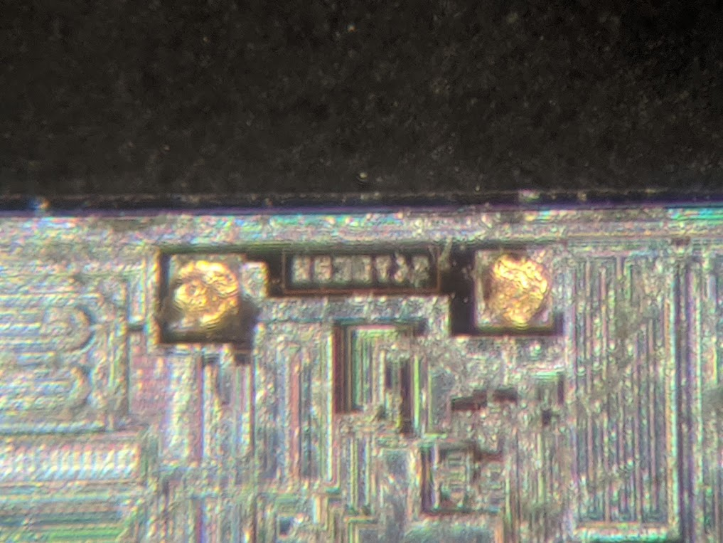 if i really push my microscope to the limit, you can see the blurry mess that is the official die ID: "RS30". this is the *same* die used in the MAX232!