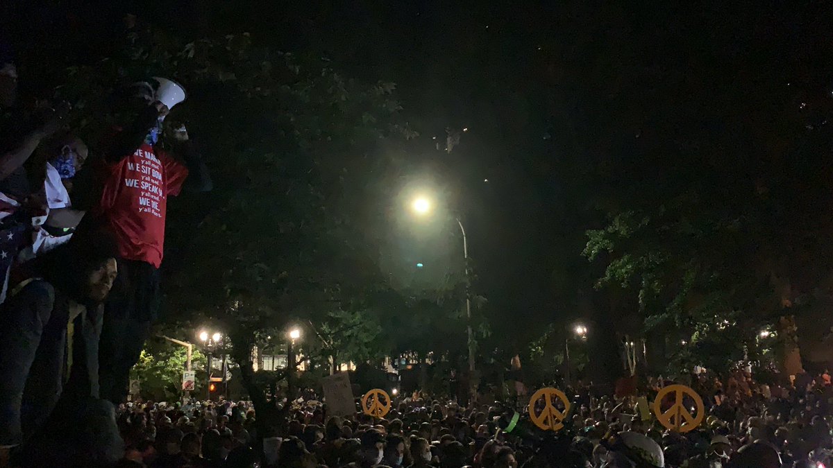 More photos of the huge crowds. Most wearing yellow or black. Many holding peace signs or signs. Many wearing helmets.