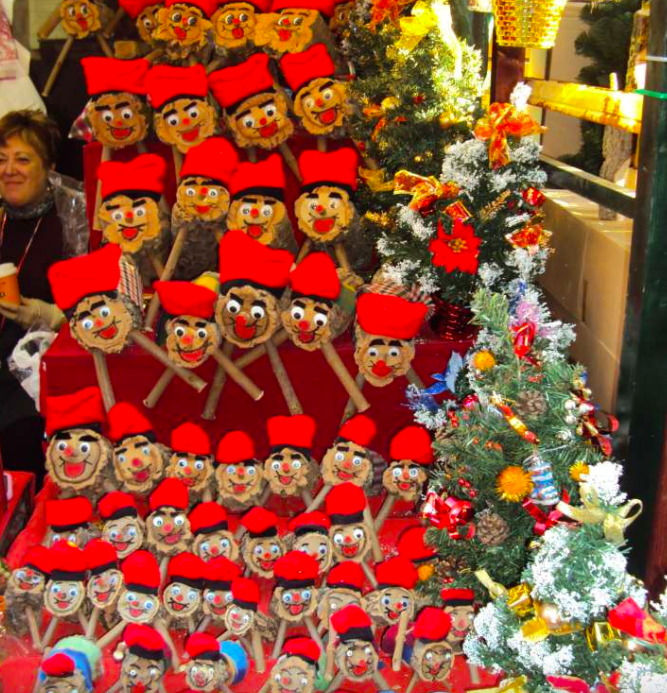 It was not a translation error. It turns out that in Barcelona, Caga Tió is a 'Christmas log' with a smiling face & red hat. The log is placed in the living room on the 8th of December and has to be fed daily with traditional Christmas food like turró (Spanish nougat).